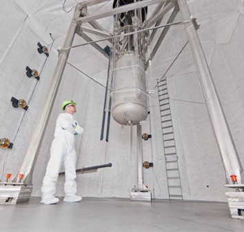 University of California, Davis, physicist Jeremy Mock inspects the LUX detector