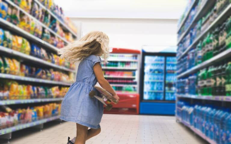 little girl from behind in a supermarket aisle