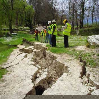 Members of the Earthquake Engineering Field Investigation Team (EEFIT) inspect t