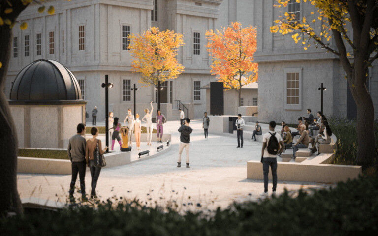 An image of the UCL Quad in Autumn, full of people, bordered by colourful trees.
