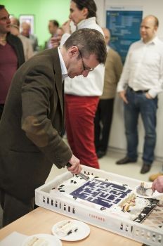 Prof Peter Coles, a crossword enthusiast, cuts into a crossword cake to mark his