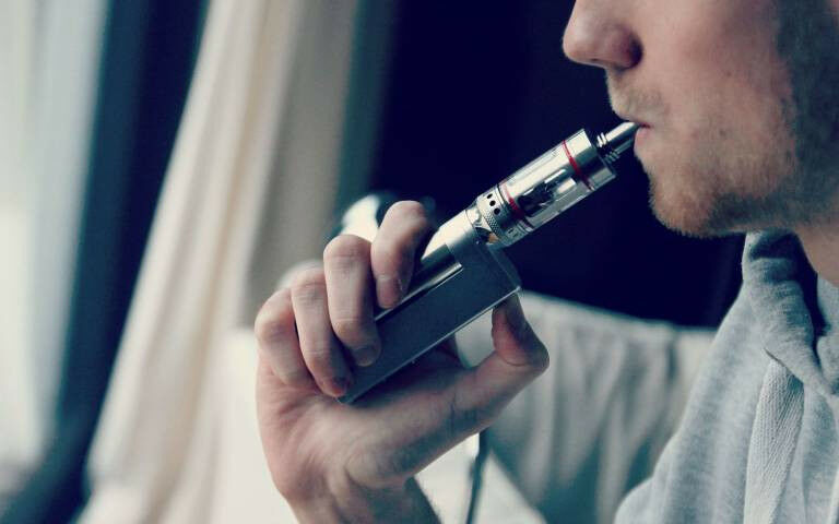 man smoking an e-cigarette
