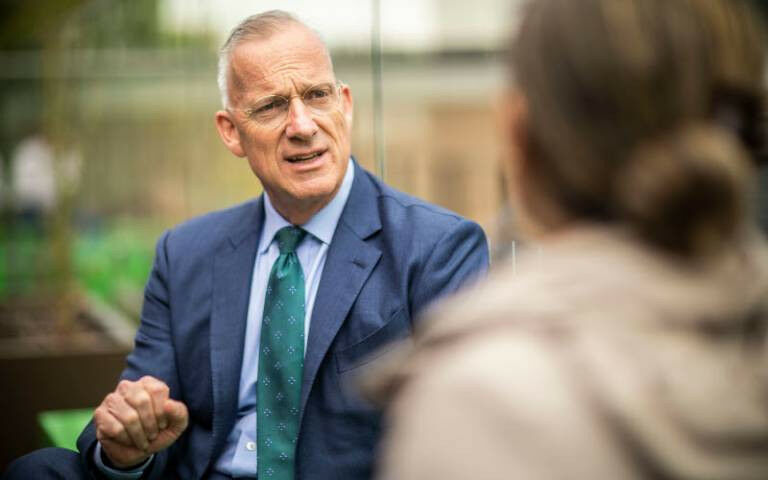 UCL President & Provost Michael Spence, in discussion with another person wh