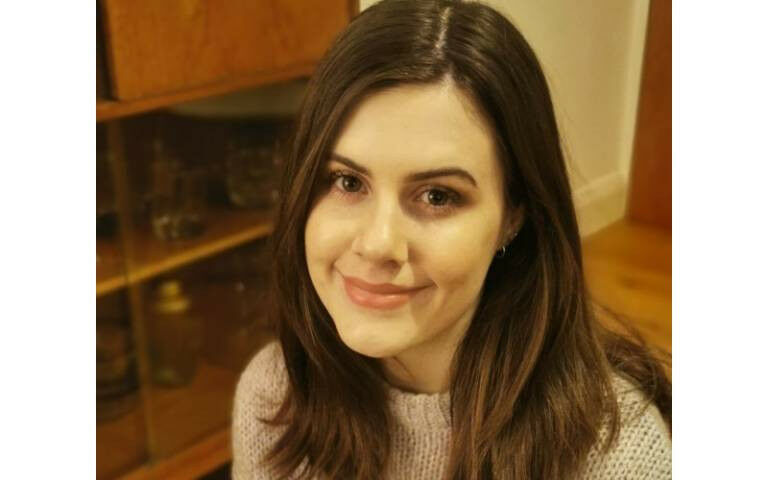 Ethne James-Souch, looking directly at the camera with a smiling expression.