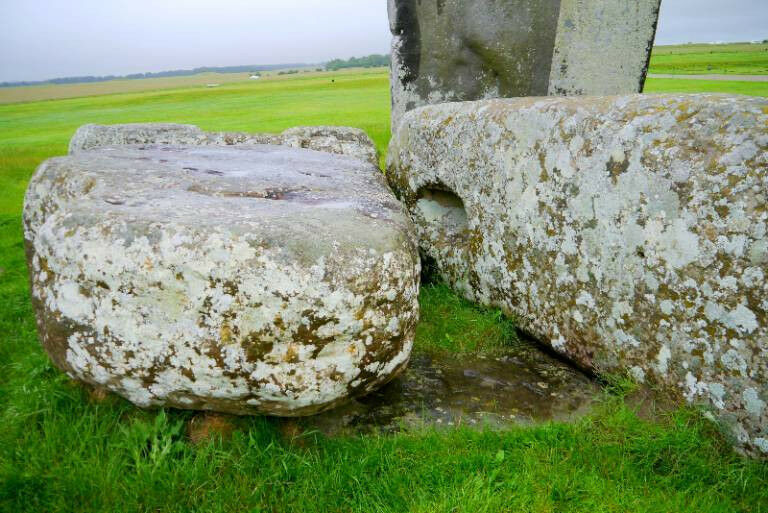 Stones from Stonehenge, some standing some fallen, with one sticking out of the