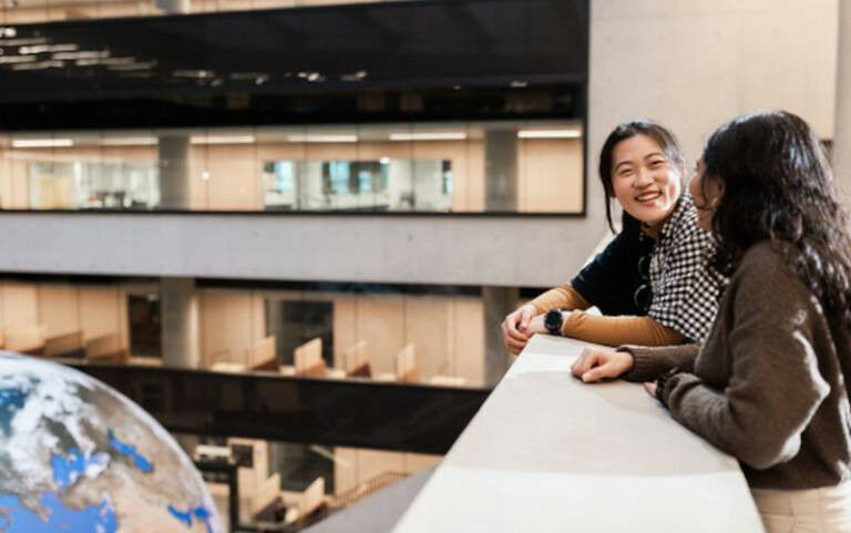Two students chat together at UCL’s Marshgate building. The ’Gaia Gl