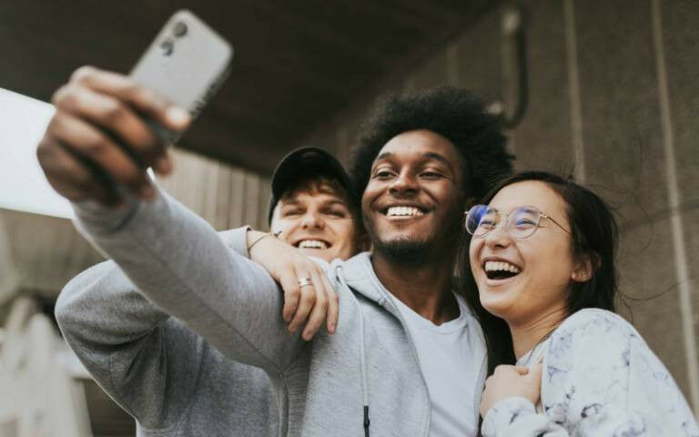Friends taking selfies